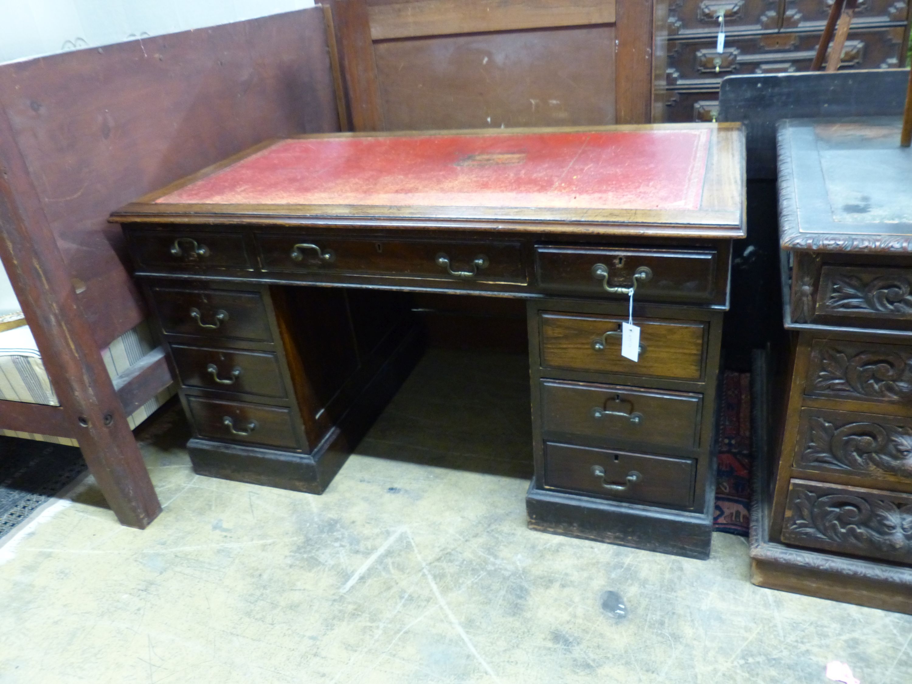 An Edwardian walnut pedestal desk, length 136cm